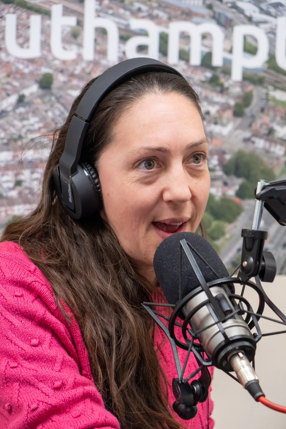 Natalie Haigh speaking into the microphone in the Voice FM studio